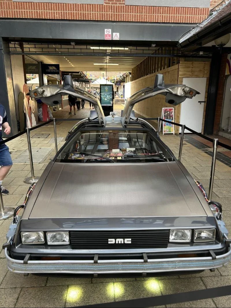 Time machine on display behind barriers with doors up