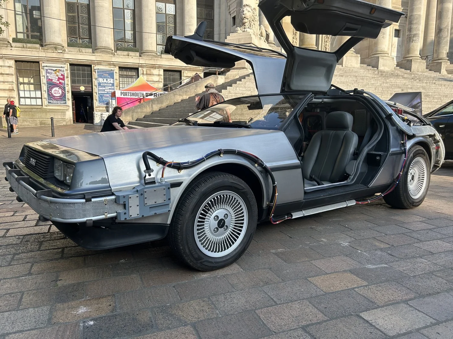 DeLorean time machine with gull-wing doors up outside Portsmouth Guildhall at Portsmouth Comic Con