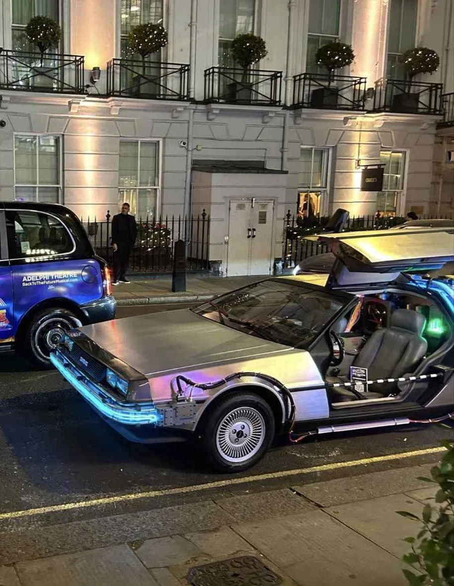 Time machine parked outside a London hotel at night