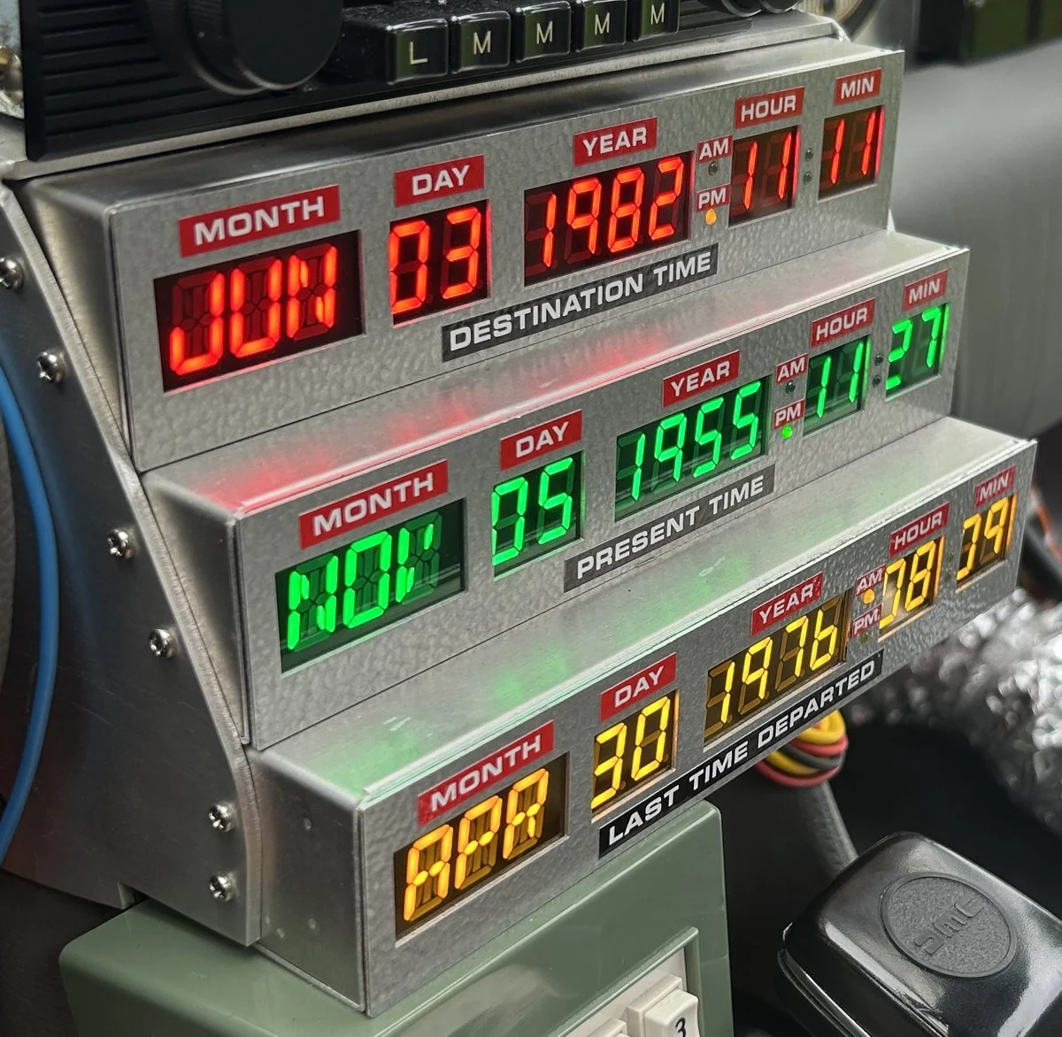 The car's real time circuits lit up red, green and amber: destination, present and last time departed
