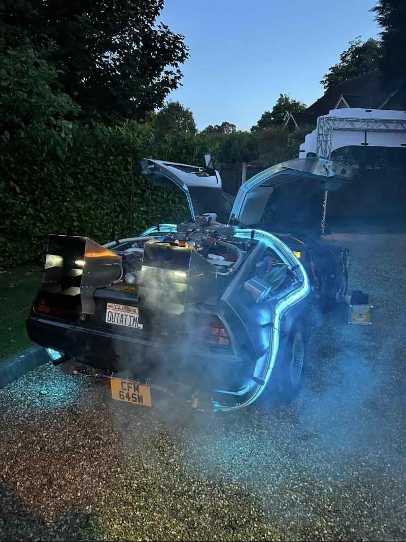 Rear of the time machine with smoke pouring from the vents and OUTATIME plate