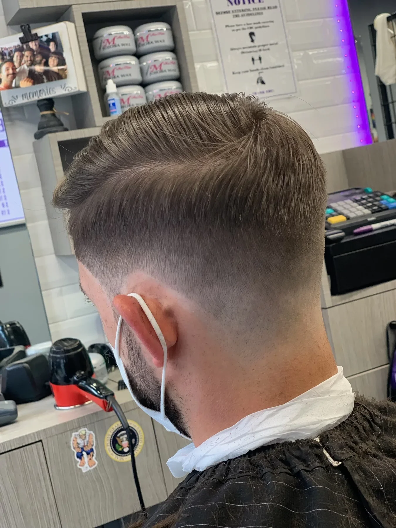 Blended skin fade and swept hair, viewed from the back