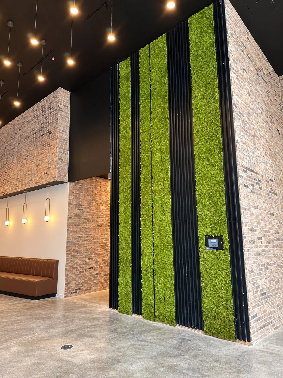 Residential lobby with fluted panels and vertical moss wall inlays