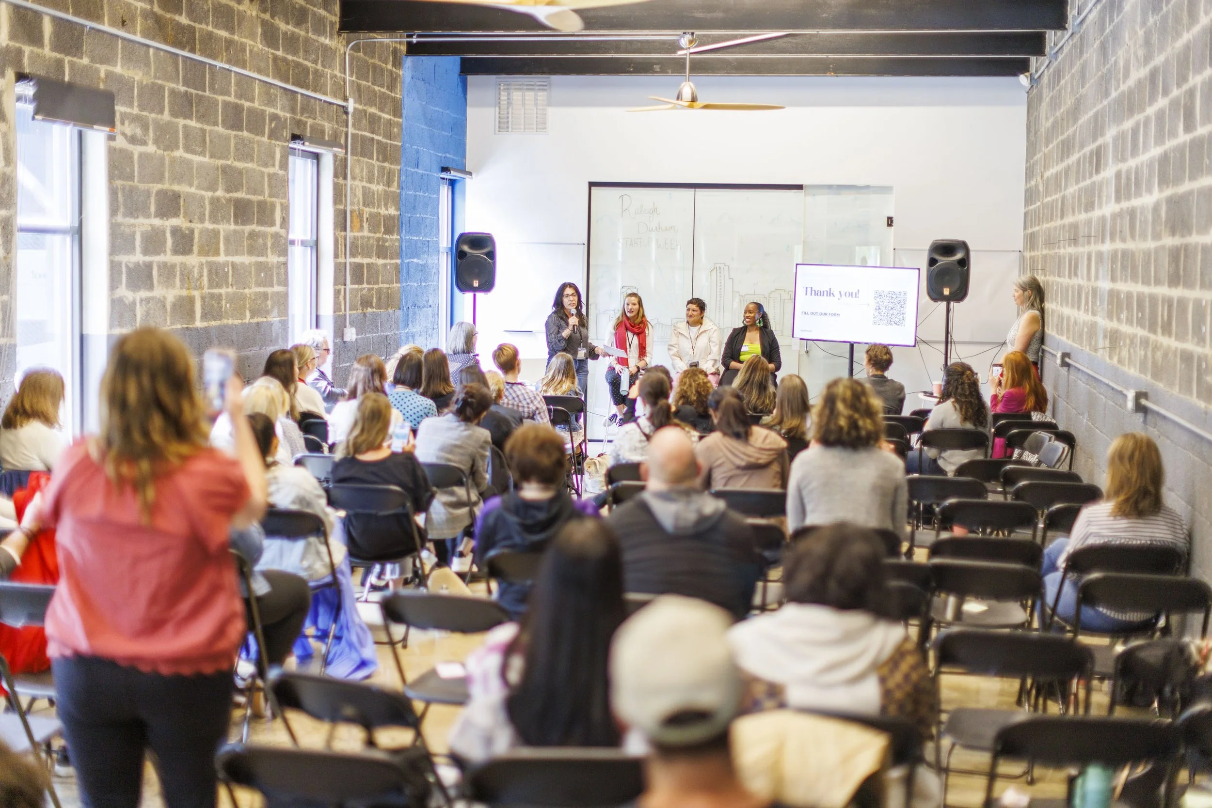 Gina leading a conversation at an event