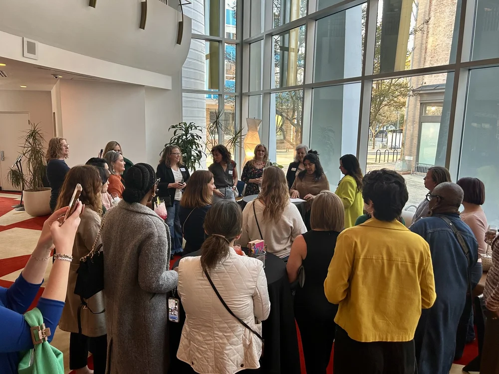Women gathered by the windows at a Women's Social