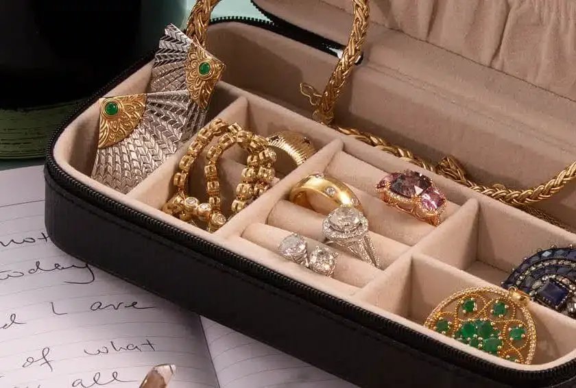Inherited jewelry in a compartmented case with rings, necklaces and gemstone pieces