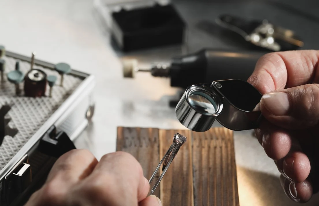Jeweler examining a diamond with a loupe