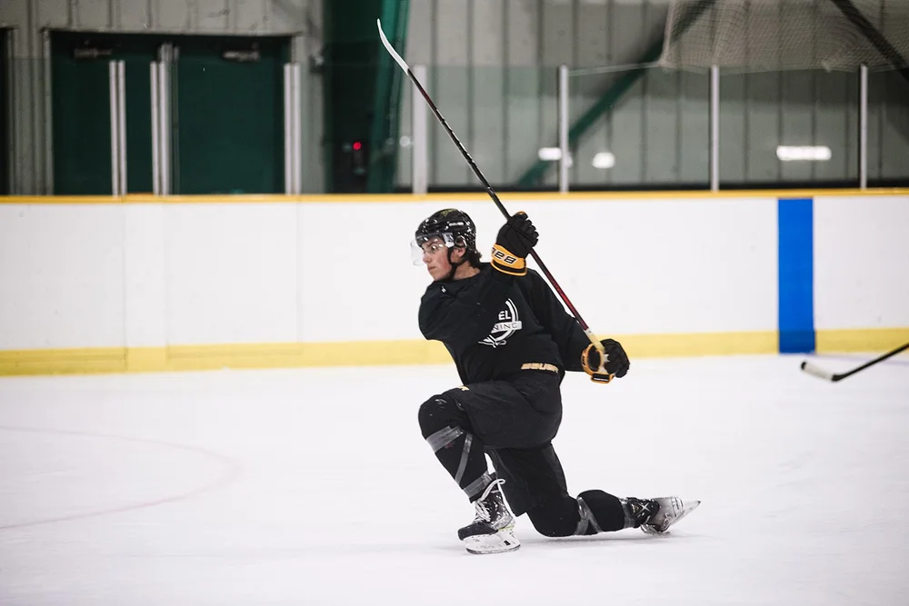 Player taking a shot from one knee during a Next Level session