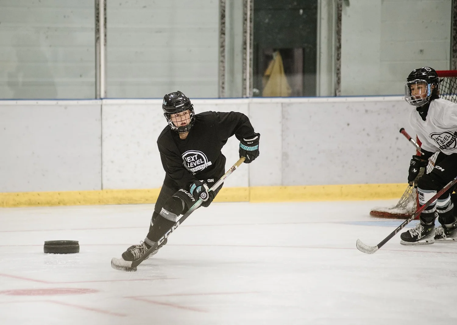 Player skating with the puck at a Next Level camp
