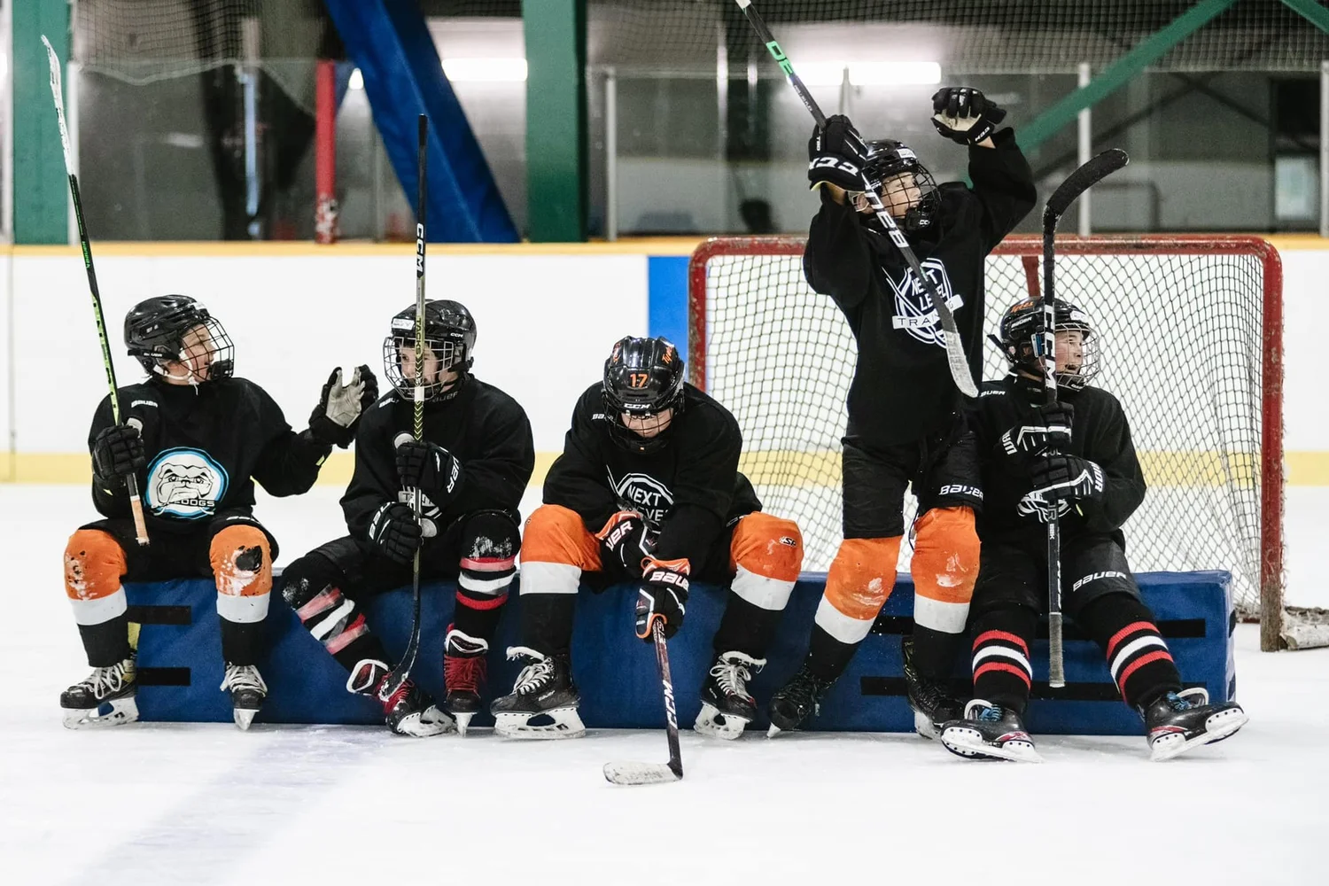 Next Level players on the bench during a session