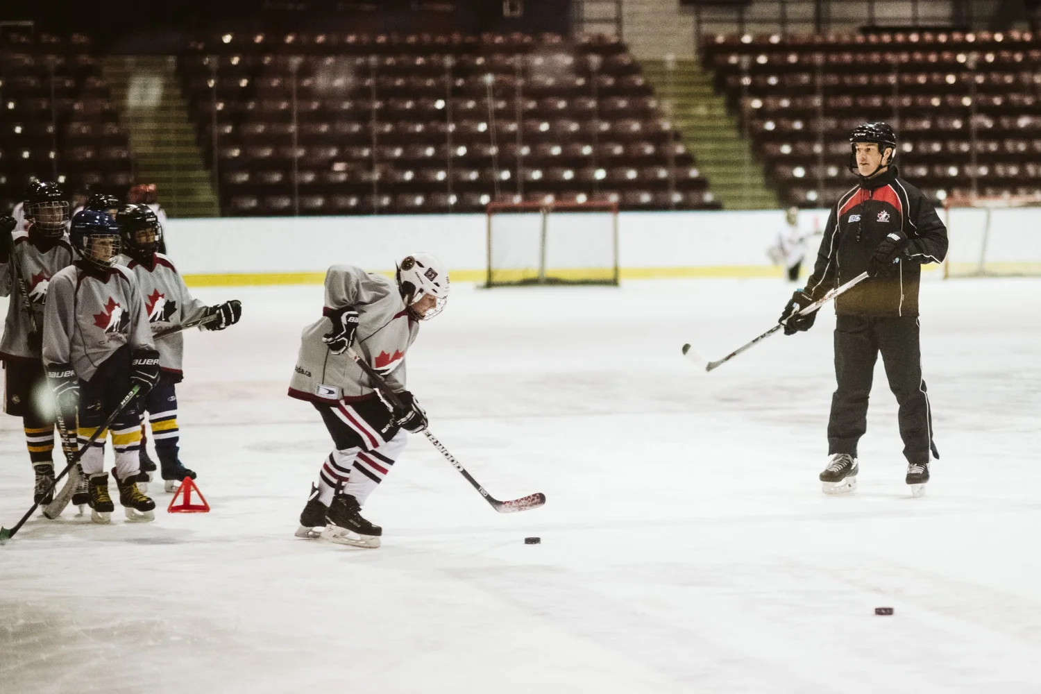 Coach running a skating drill with players
