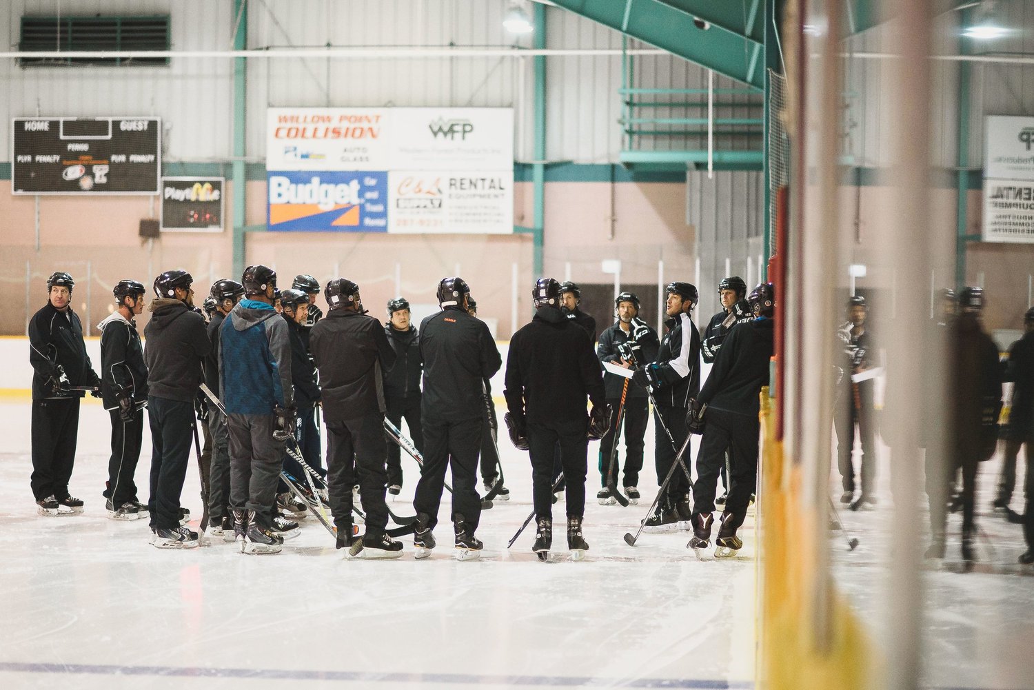 Players and coaches gathered on the ice at a Next Level clinic