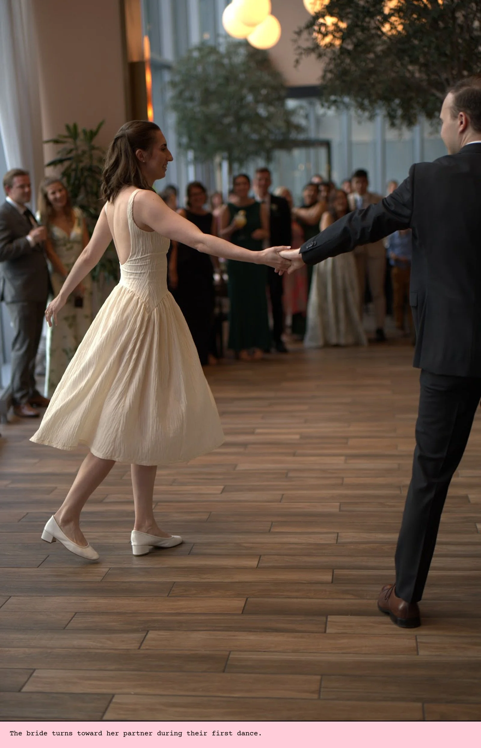 The bride turns toward her partner during their first dance.