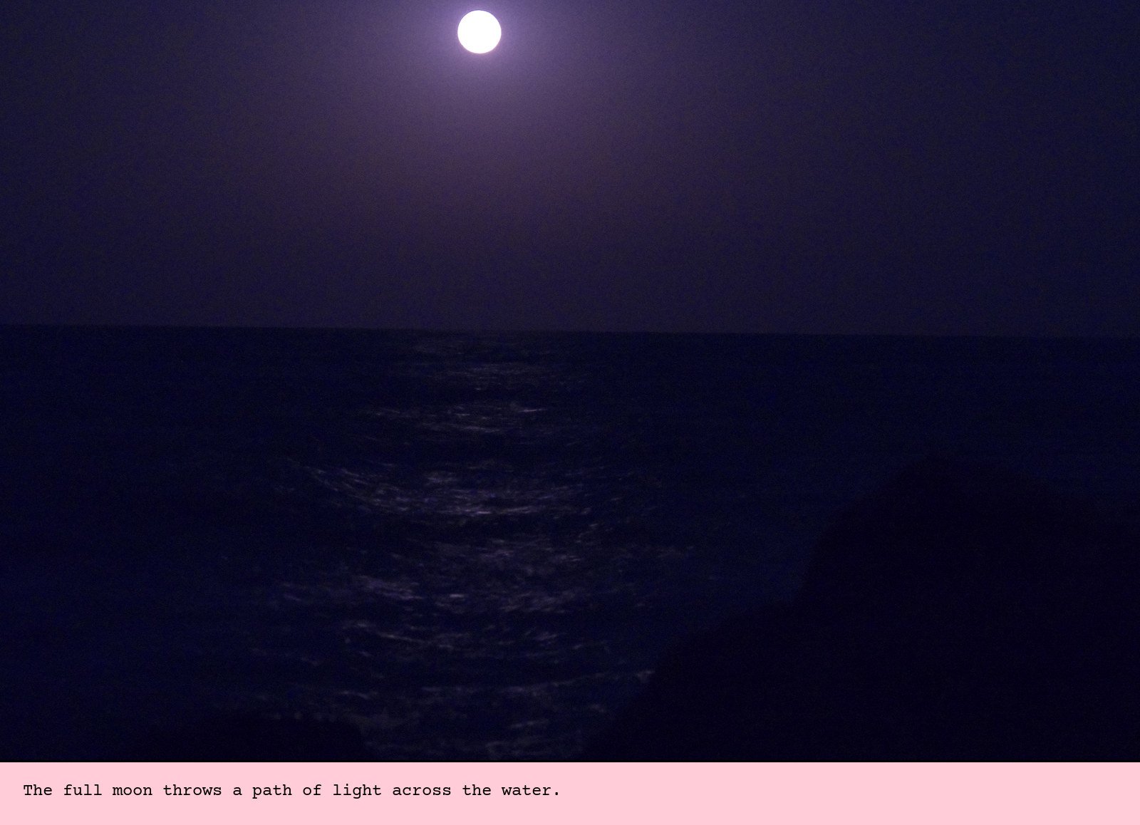 The full moon throws a path of light across the water.