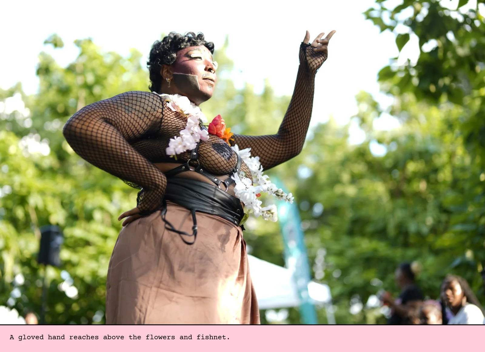 A gloved hand reaches above the flowers and fishnet.