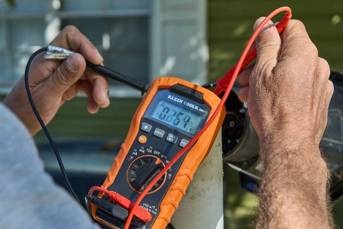 Kennedy Electric electrician testing a circuit with a multimeter