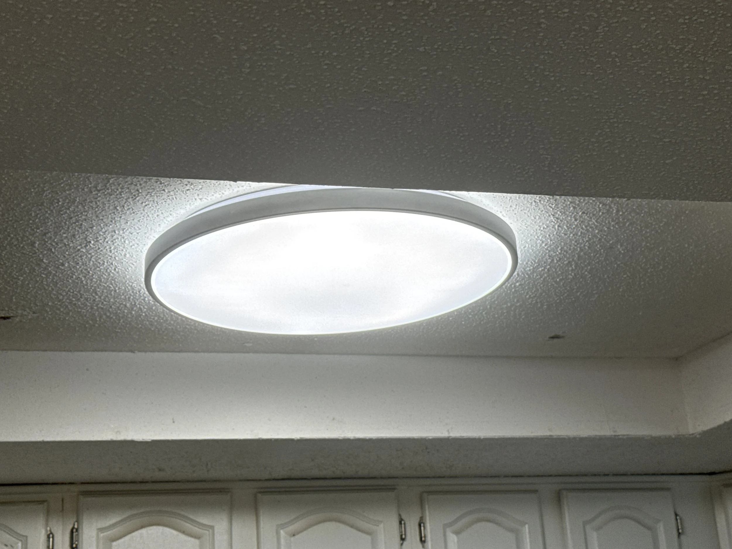 Round LED flush-mount ceiling light fixture installed