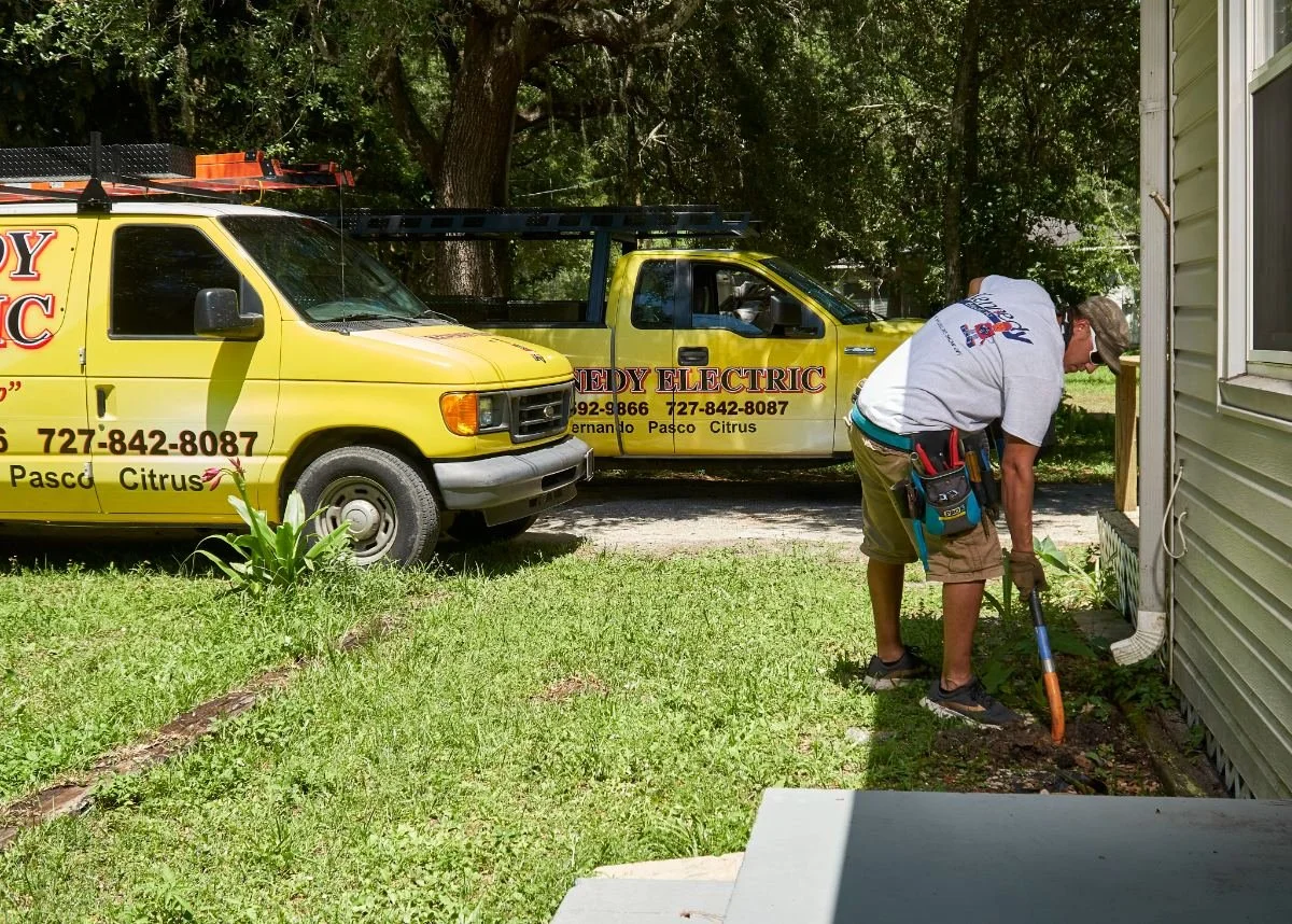 Kennedy Electric electrician working outside a home