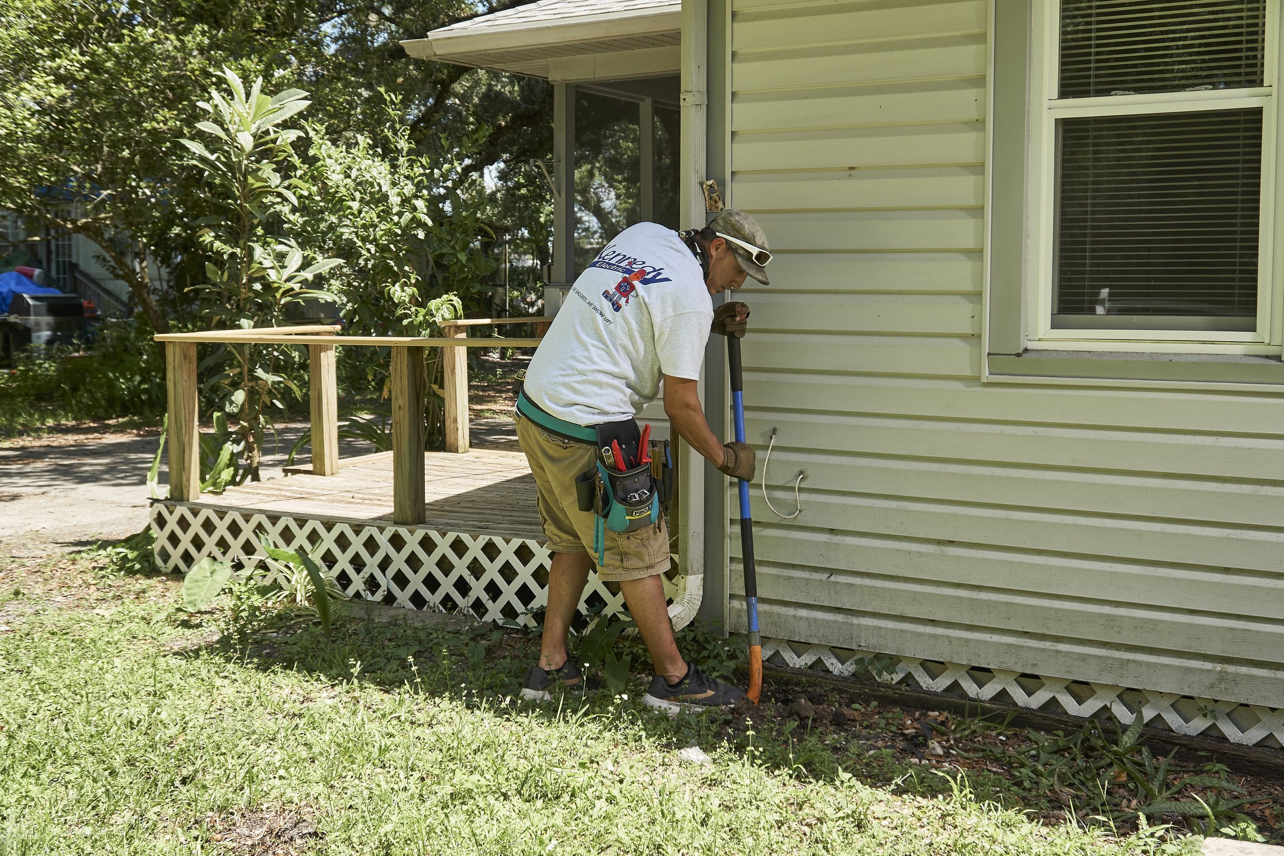 Worker at exterior of a home near a deck