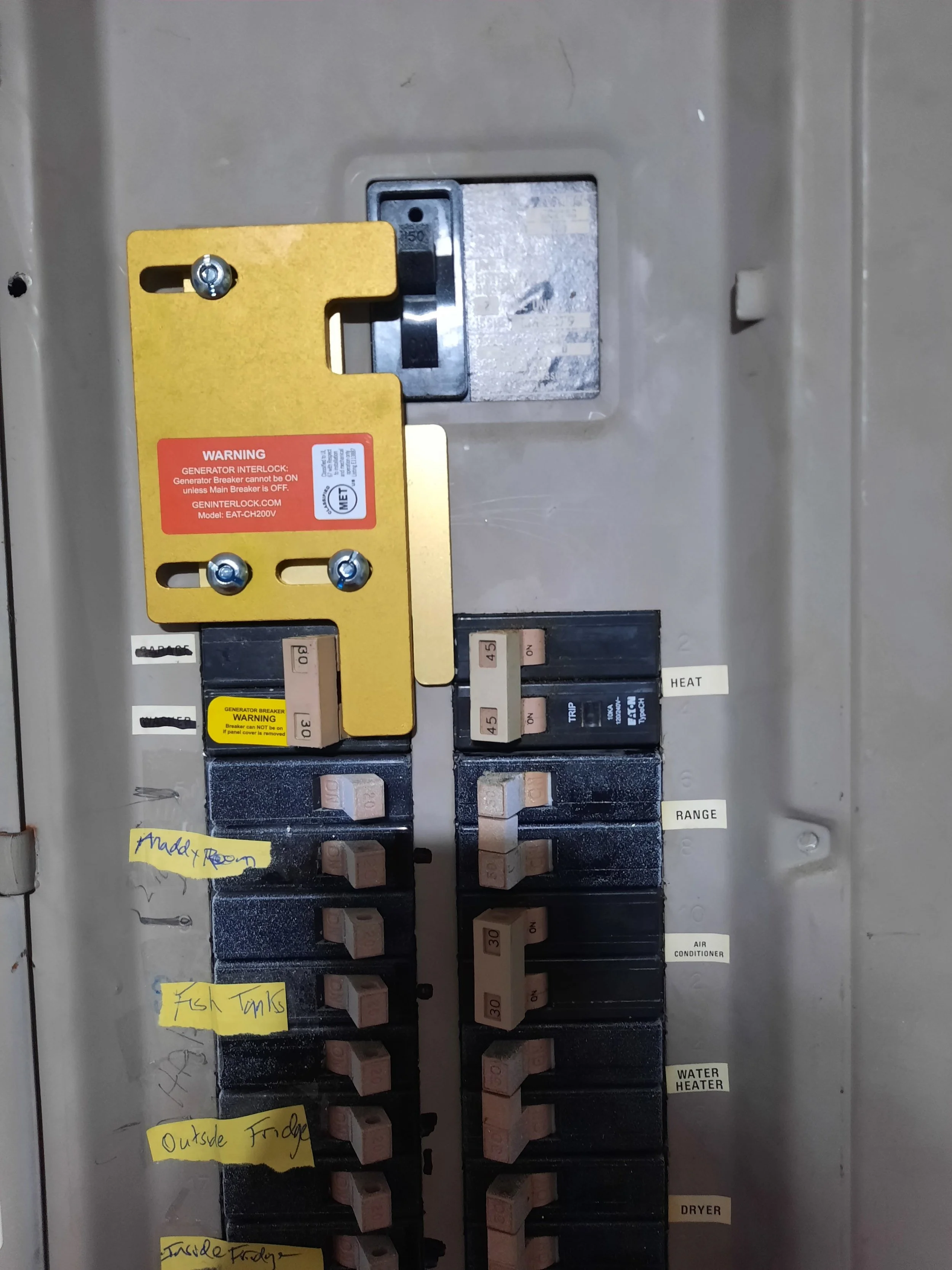 Close-up of an open residential breaker panel, deadfront removed, breakers + main visible