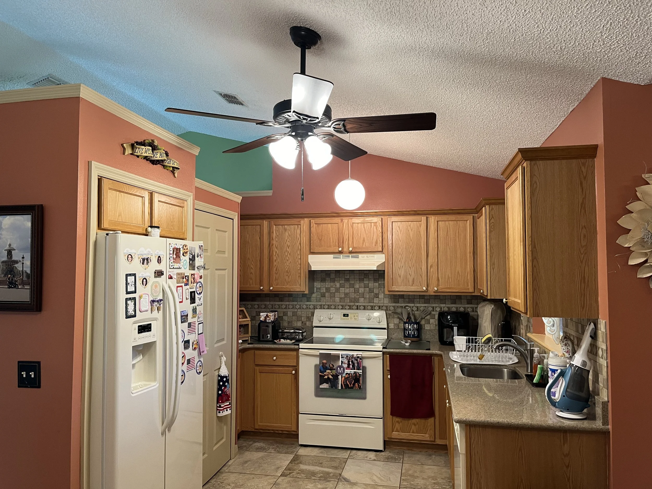 Residential kitchen with a ceiling fan and lighting