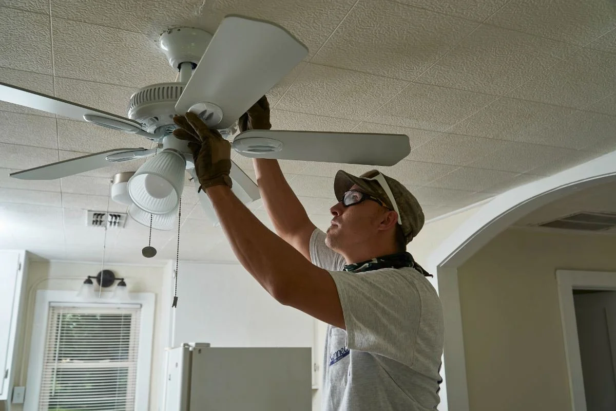 Kennedy Electric electrician installing a ceiling fan