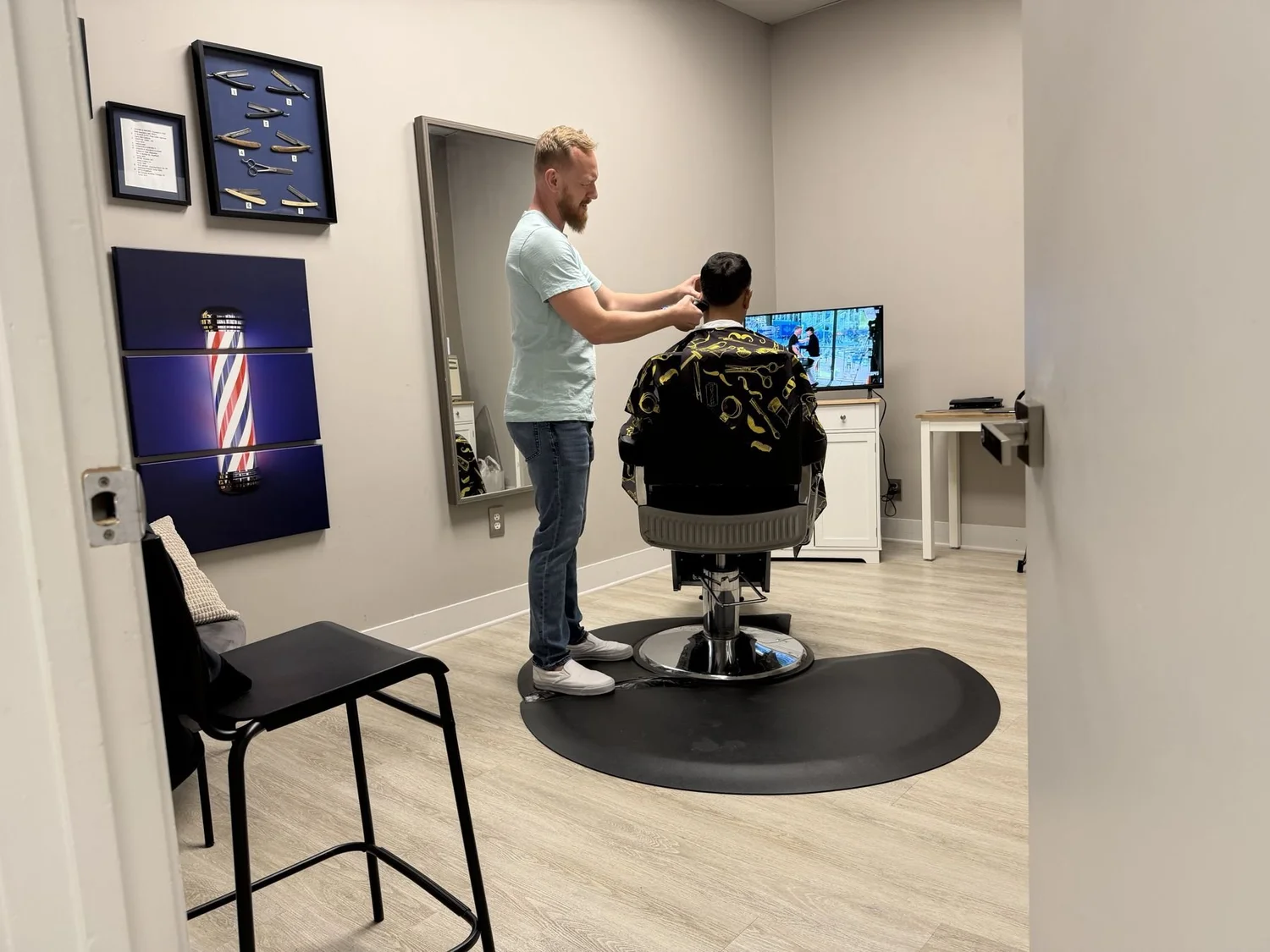 Barber Scott Yates giving a haircut at Studio XO Salon