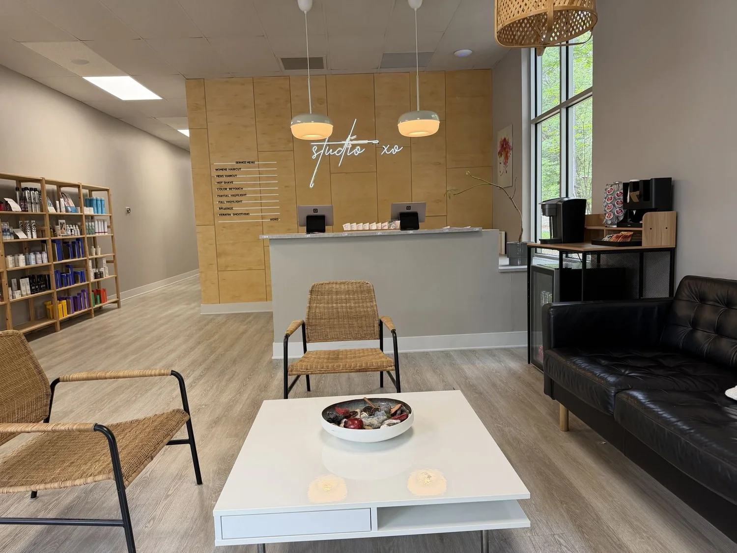 Lounge seating and retail shelves at Studio XO Salon