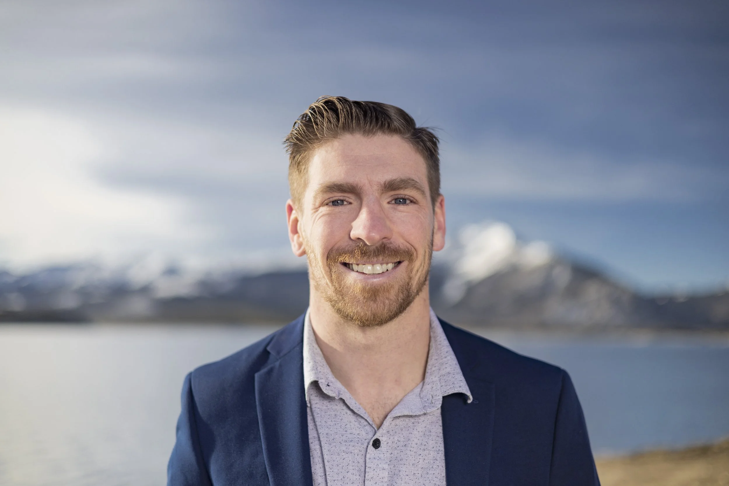 Patrick Linfante smiling with the Colorado mountains behind him