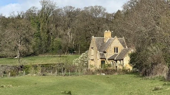 A stone cottage at the edge of the woods