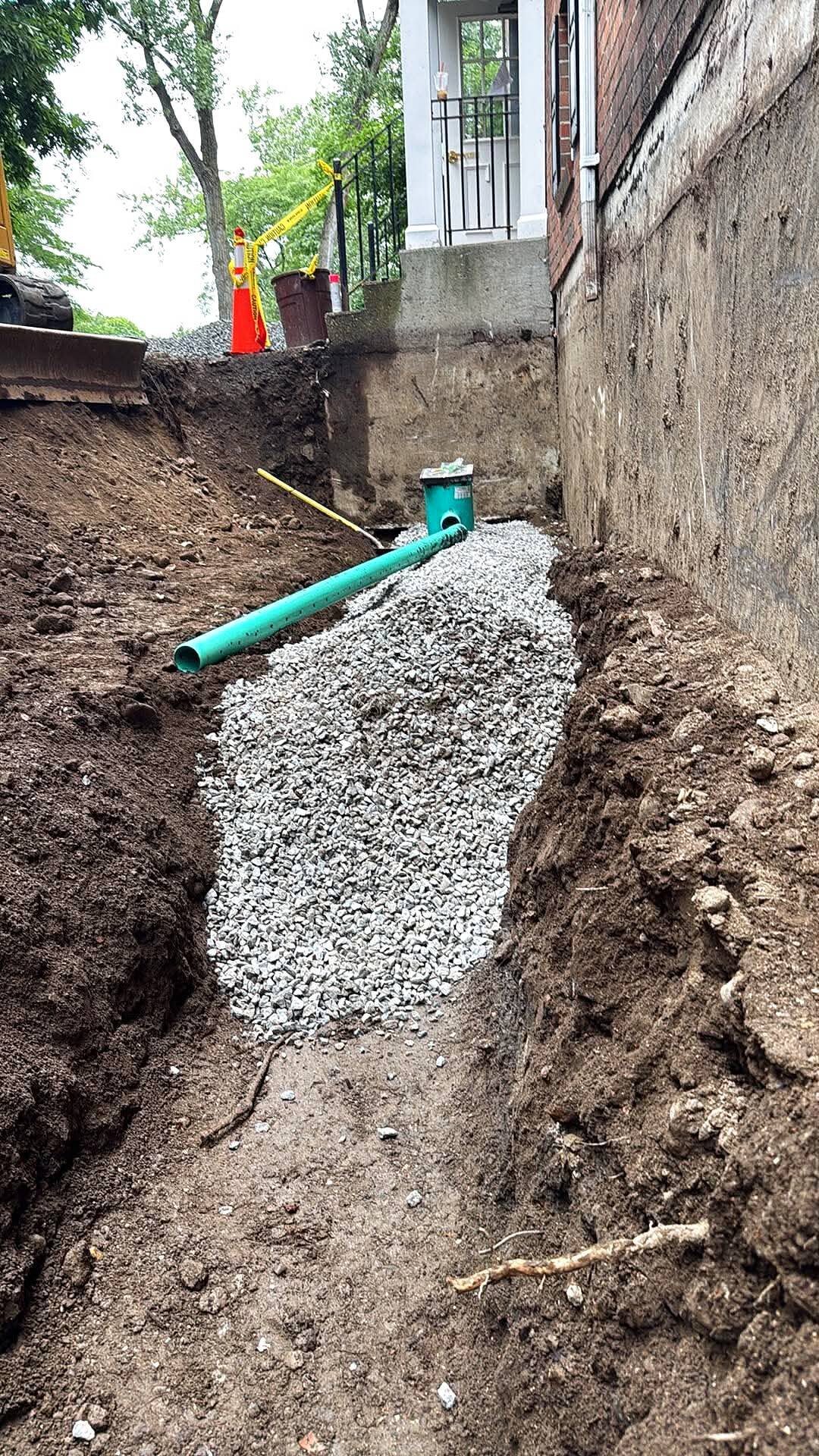 Foundation trench with drainage pipe and stone base