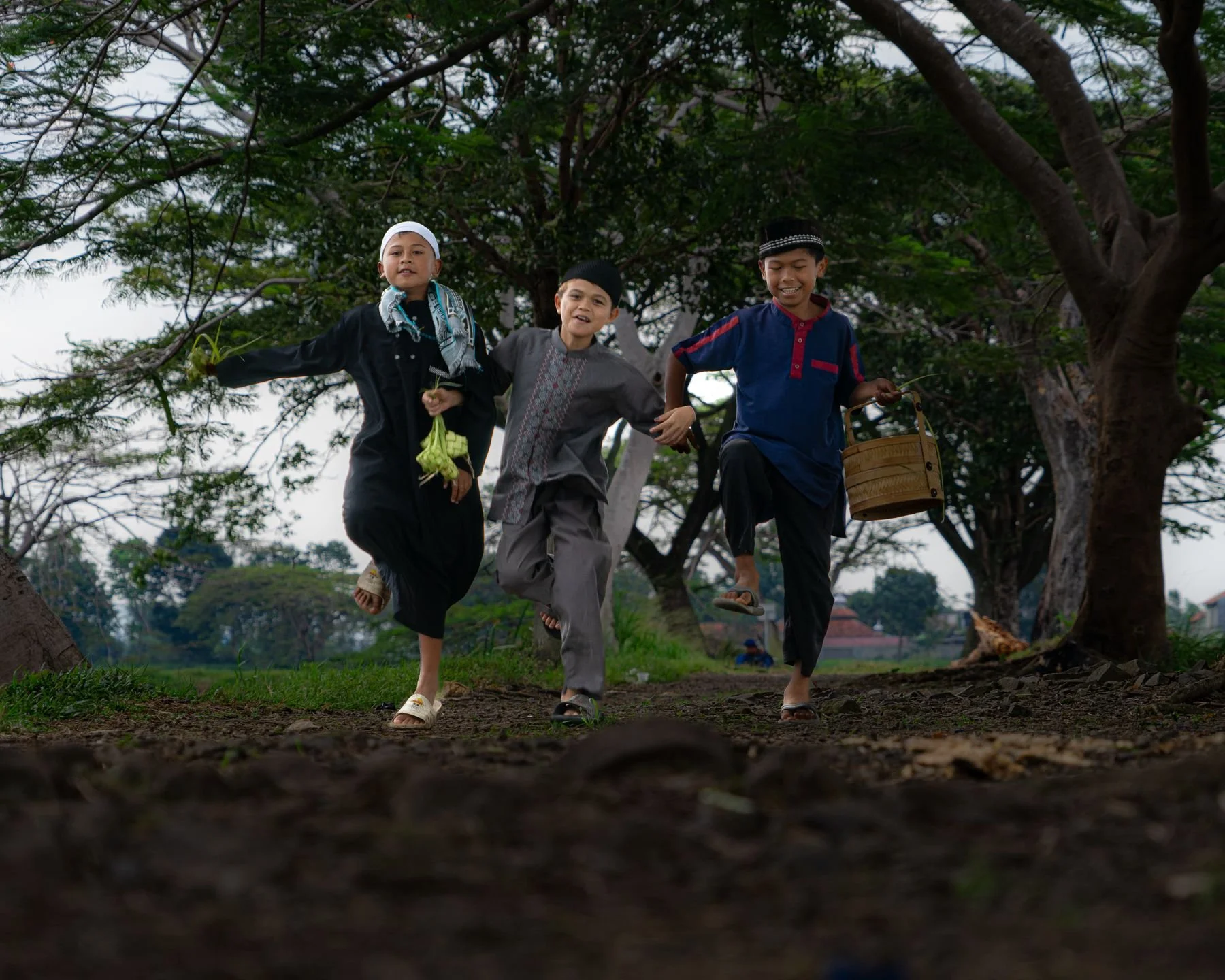 Three children running happily down a path