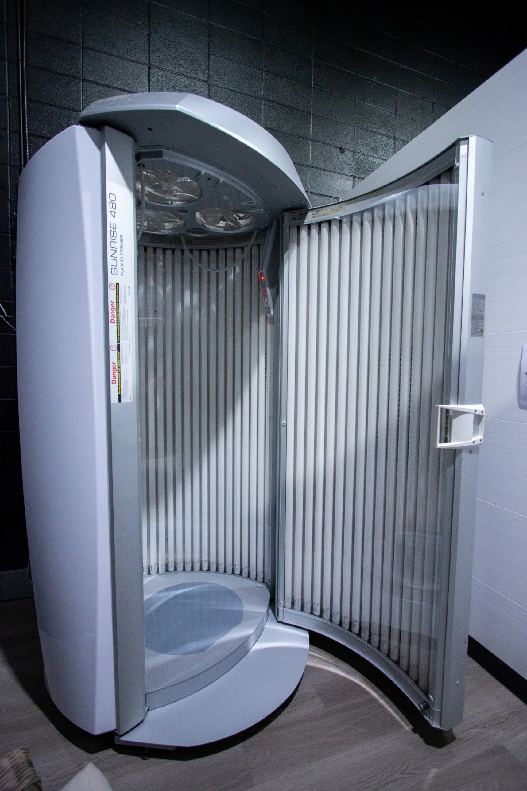 The Ergoline Sunrise 480 stand-up tanning booth at HDF with its door open