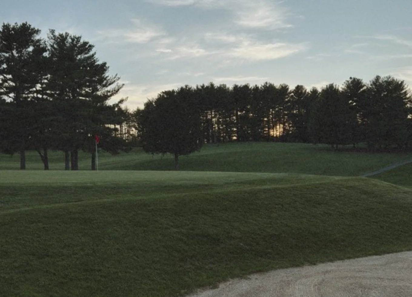 Sandhills golf course under a cloudy evening sky
