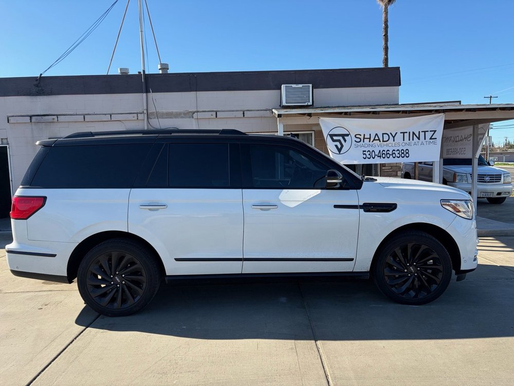 White full-size SUV with window tint outside the Shady Tintz shop in Yuba City