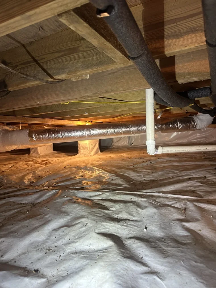 Crawlspace floor liner beneath insulated ductwork
