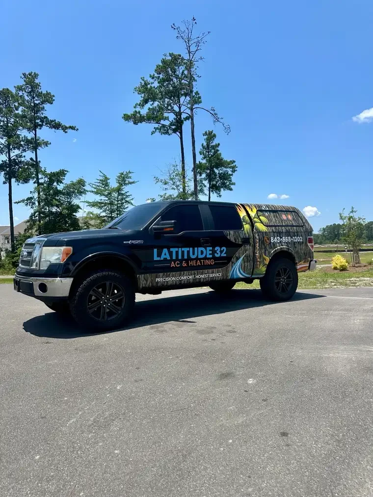 Latitude 32 AC and Heating’s black truck with its camouflage wrap