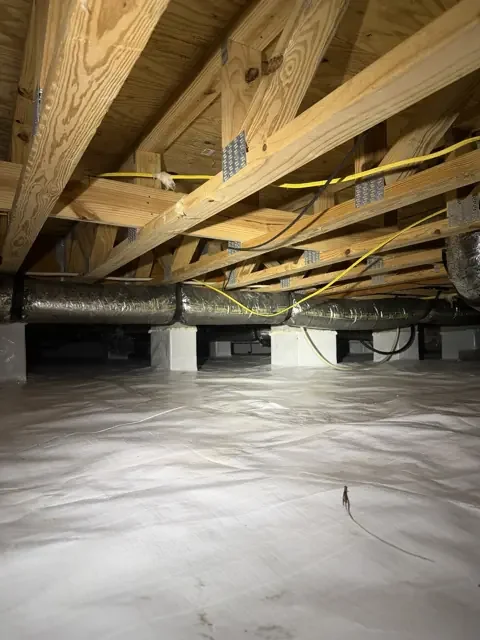 Another view of the crawlspace liner and supported insulated ducts