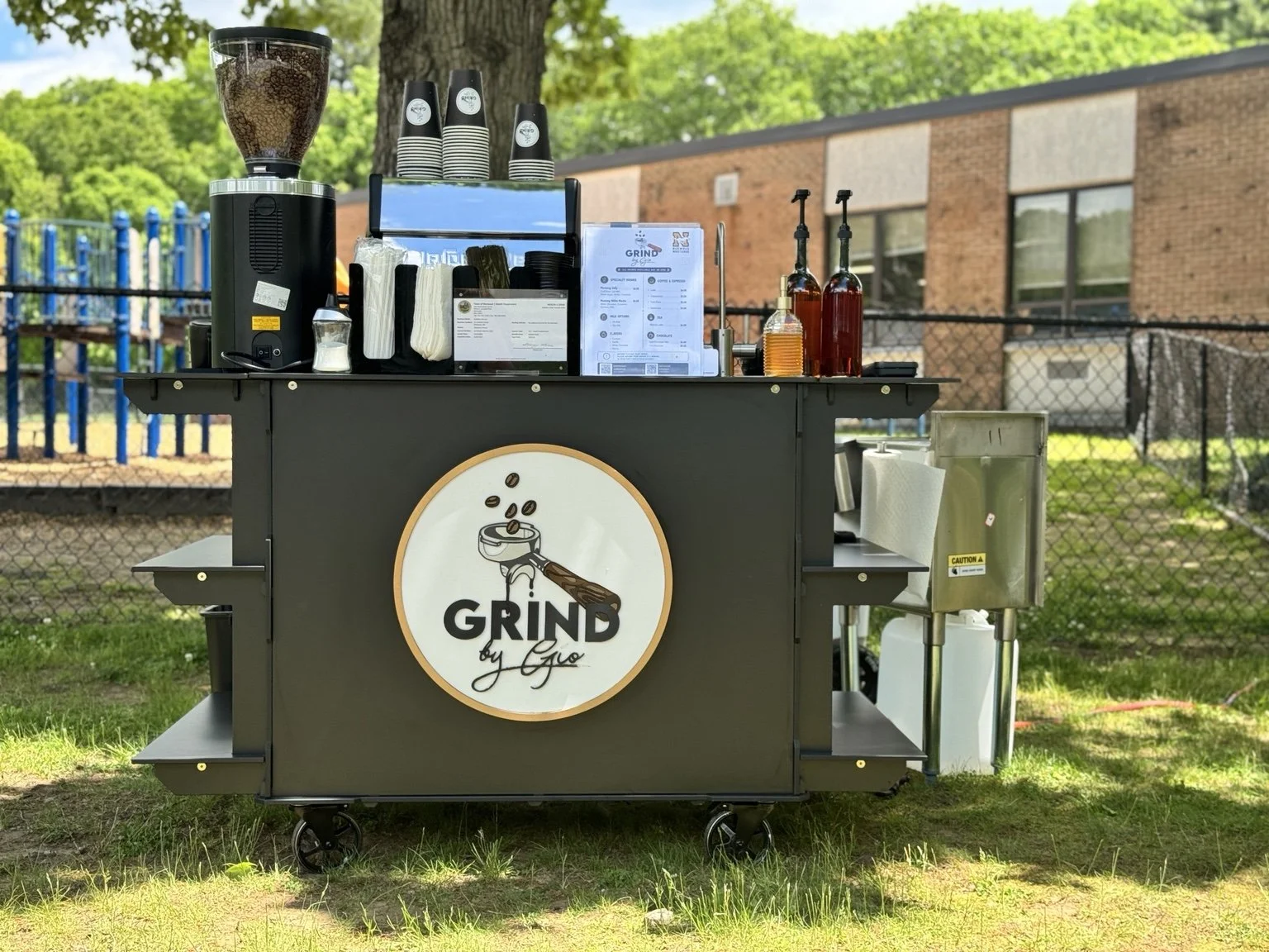 Grind by Gio espresso cart ready to serve guests at an outdoor gathering