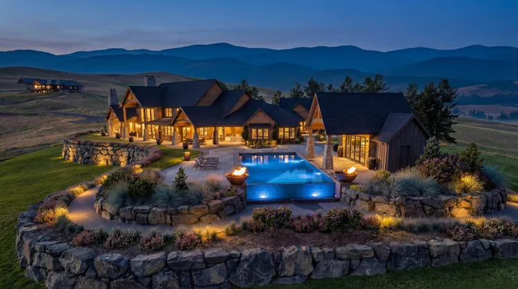 Solitude infinity pool, fire bowls and terraced gardens lit at dusk