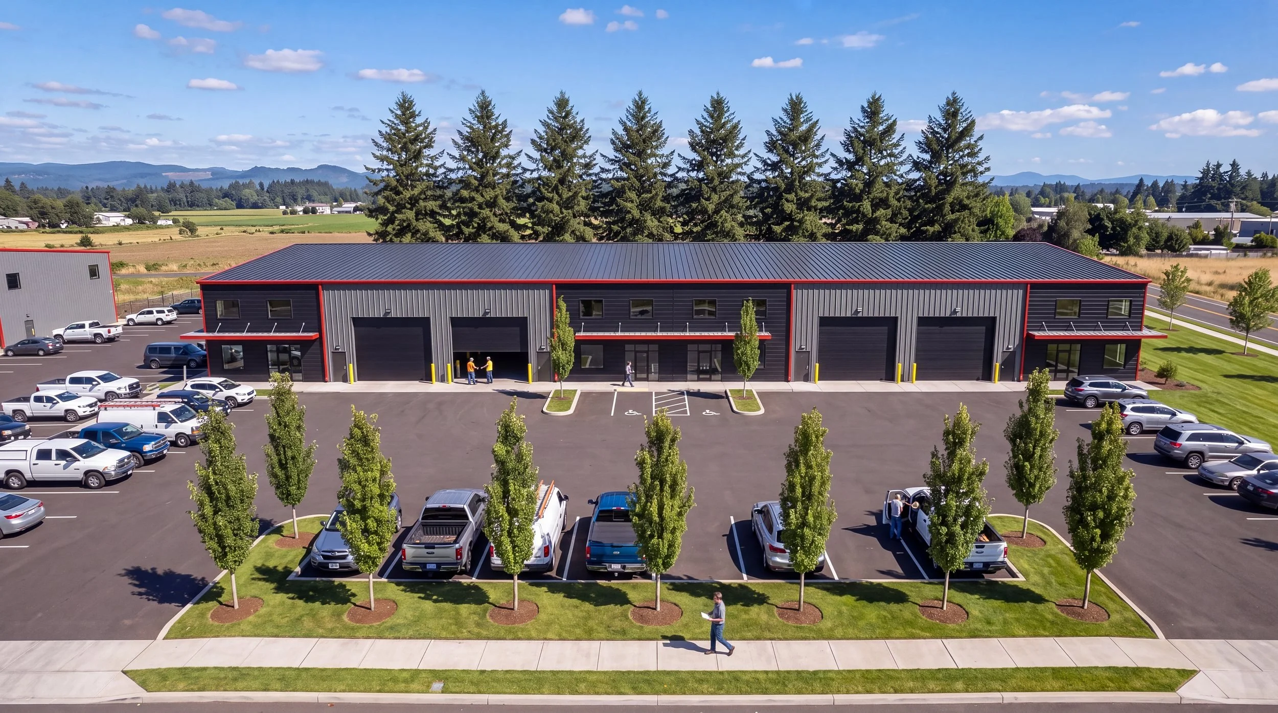 Aerial daytime view of the North Fork Industrial front facade and tree-lined parking lot