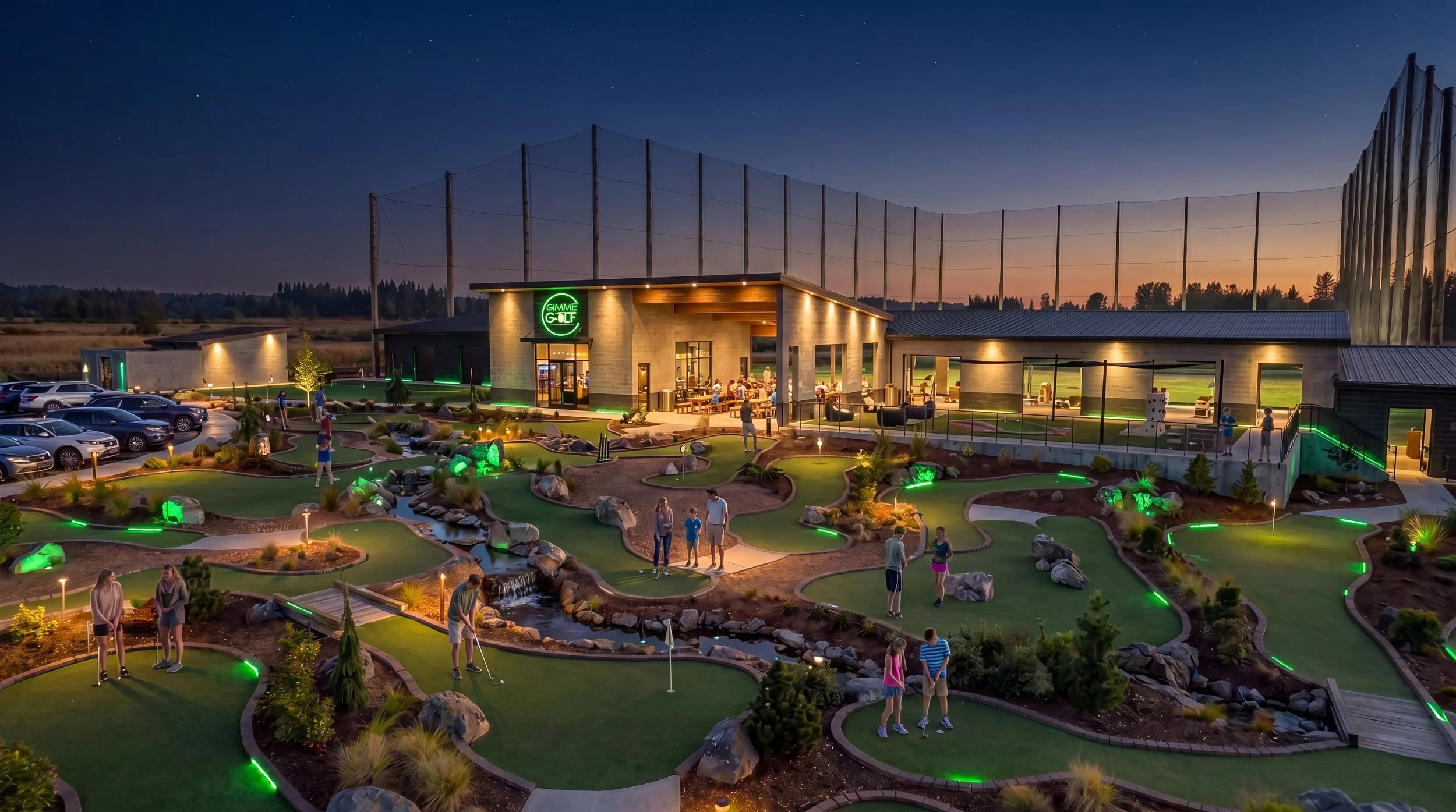 Gimme Golf mini golf course lit up at night in front of the clubhouse