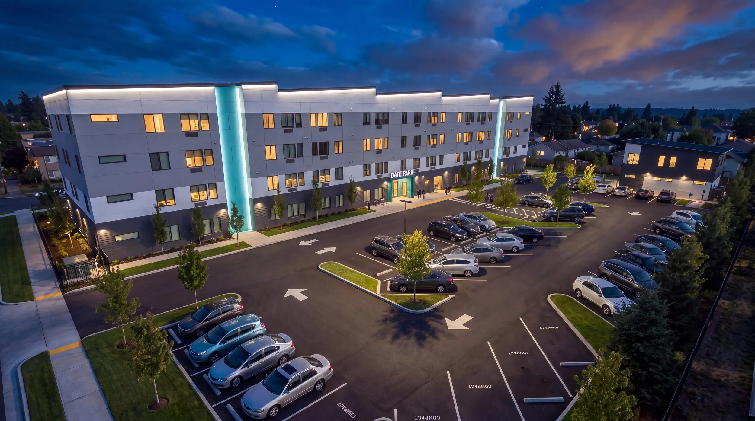 Aerial dusk view of Date Park and its parking lot with lit entry signage