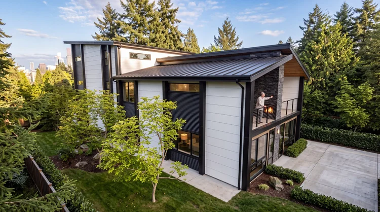 Aerial corner view of SE Quadplex with a standing-seam roof and the Portland skyline beyond