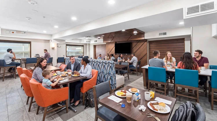 Holiday Inn Express breakfast area with booth, table and counter seating