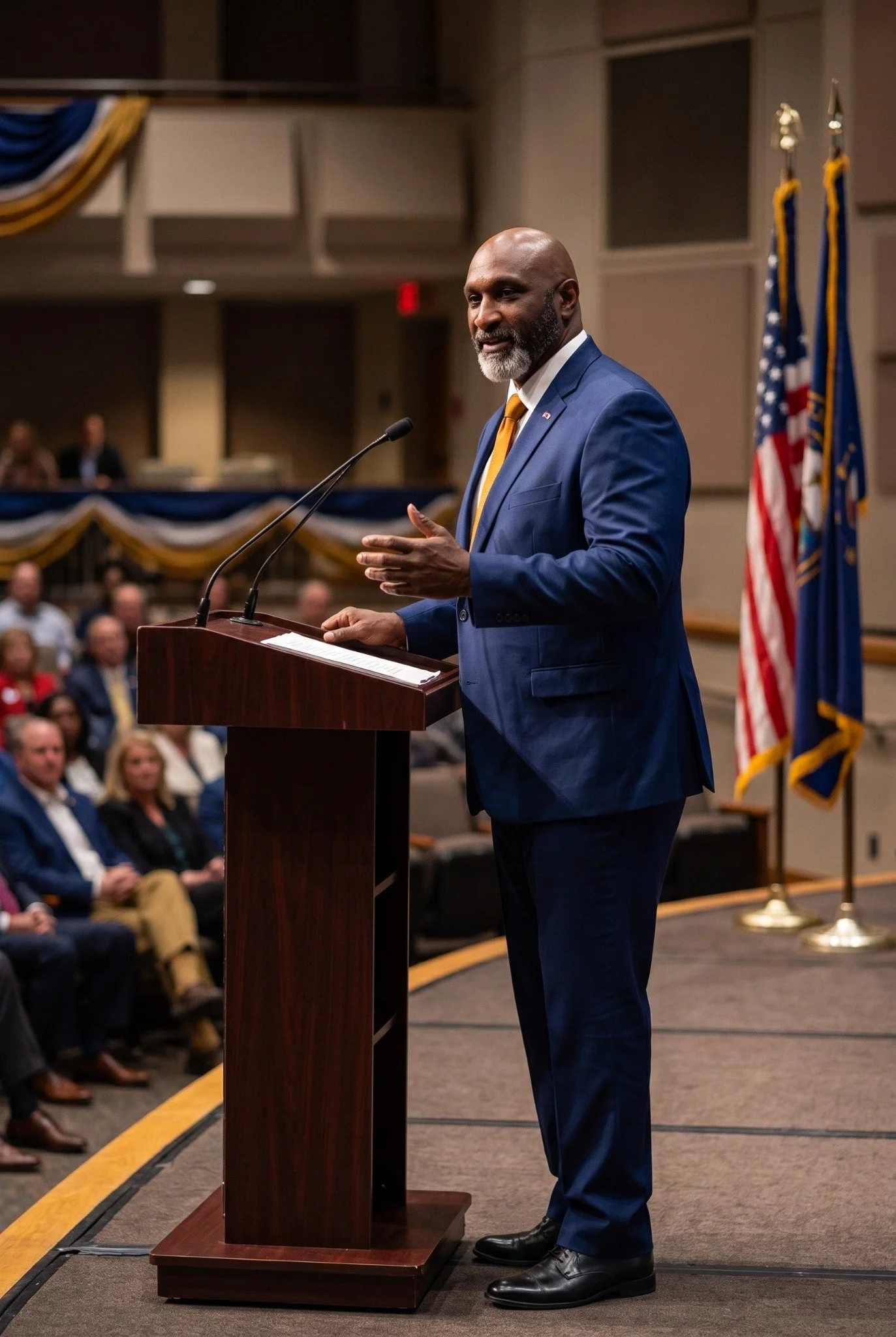 Andraé Evans speaking at a lectern