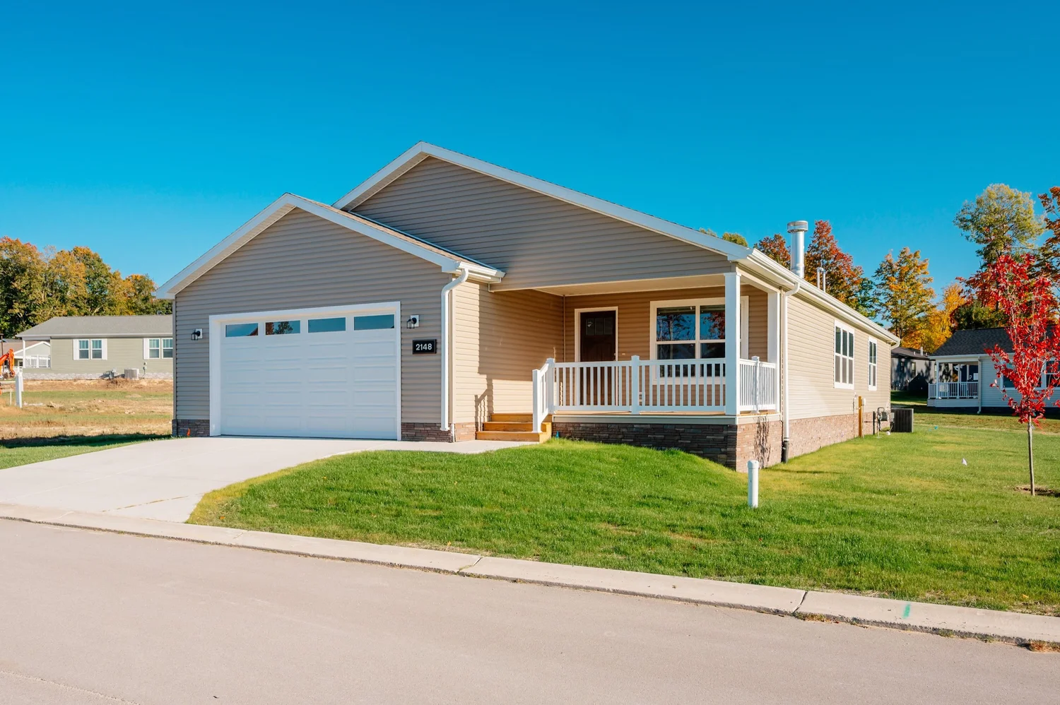 Front of 2148 Alta Vista Dr with the two-car garage and covered porch
