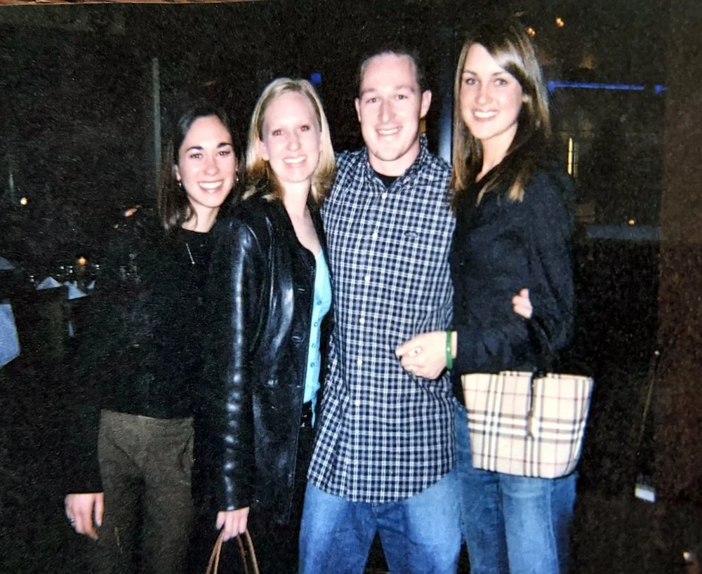 Mike with his two cousins and his sister, arm in arm at a restaurant