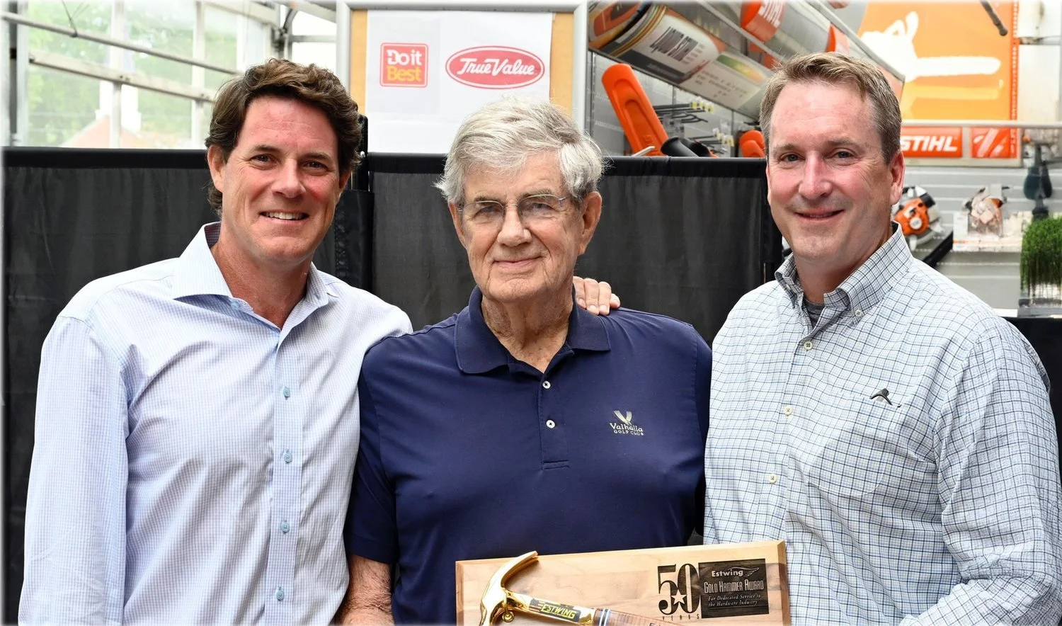 Ed Lewis with colleagues holding a Golden Hammer award