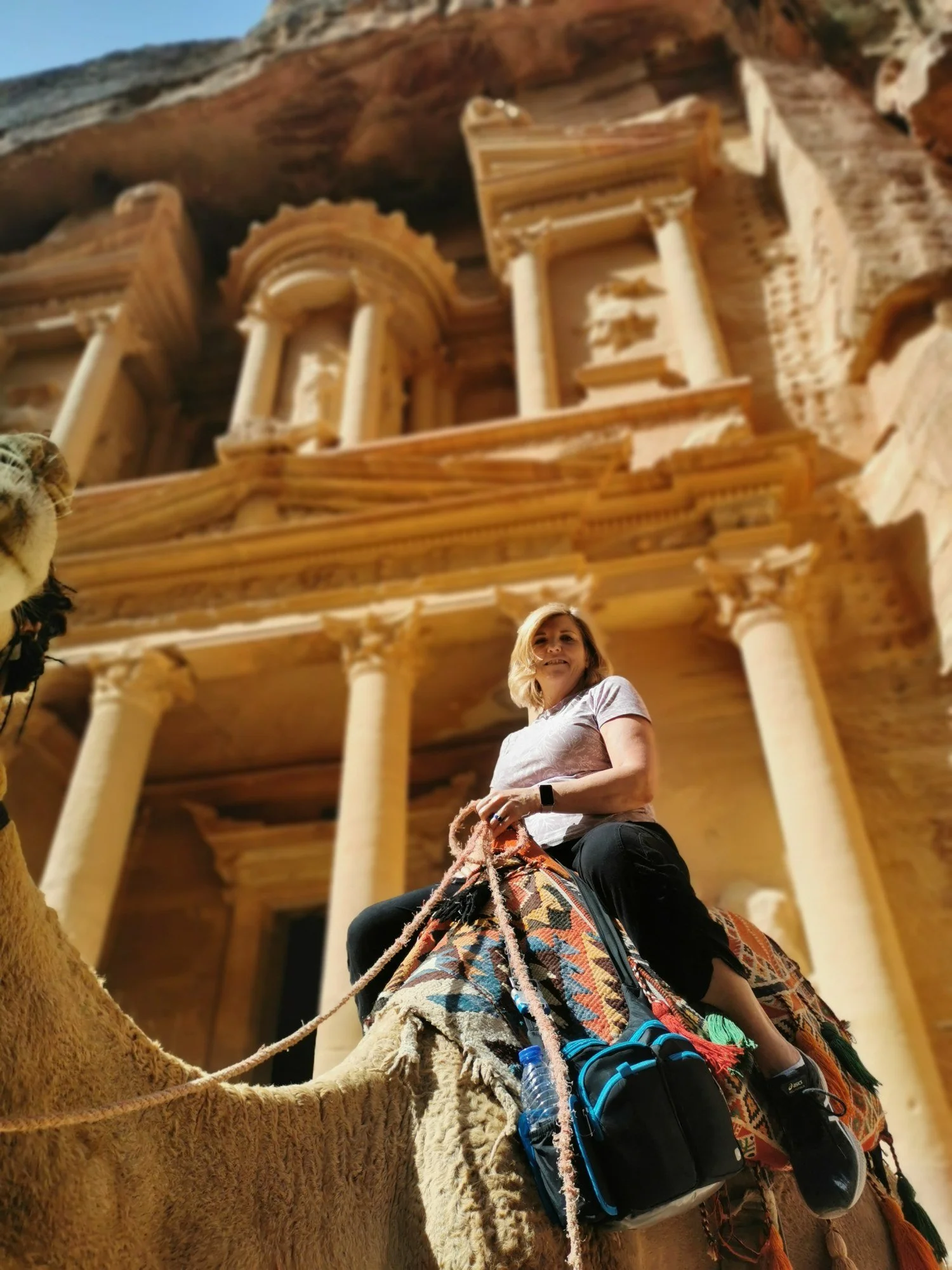 Karen Lantigua on a camel in front of the Treasury at Petra, Jordan